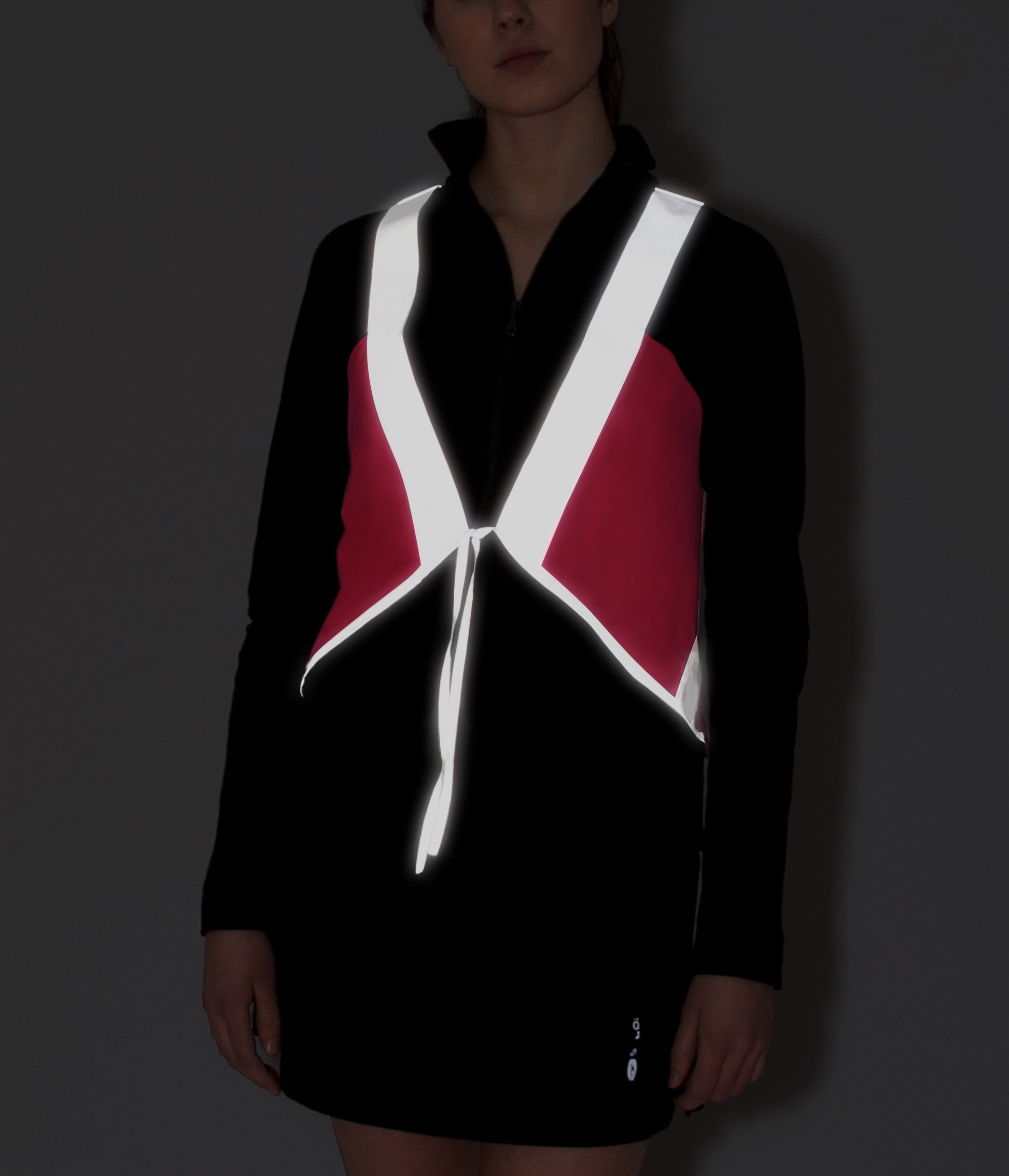 model wears cute vespert eco cotton candy neon pink stylish reflective hi vis safety vest for women reflecting clothing high visibility gear accessory womens fashion bike bike cycling walk run running dog walking walker night sustainable nighttime bright 3M scotchlite made in NYC USA