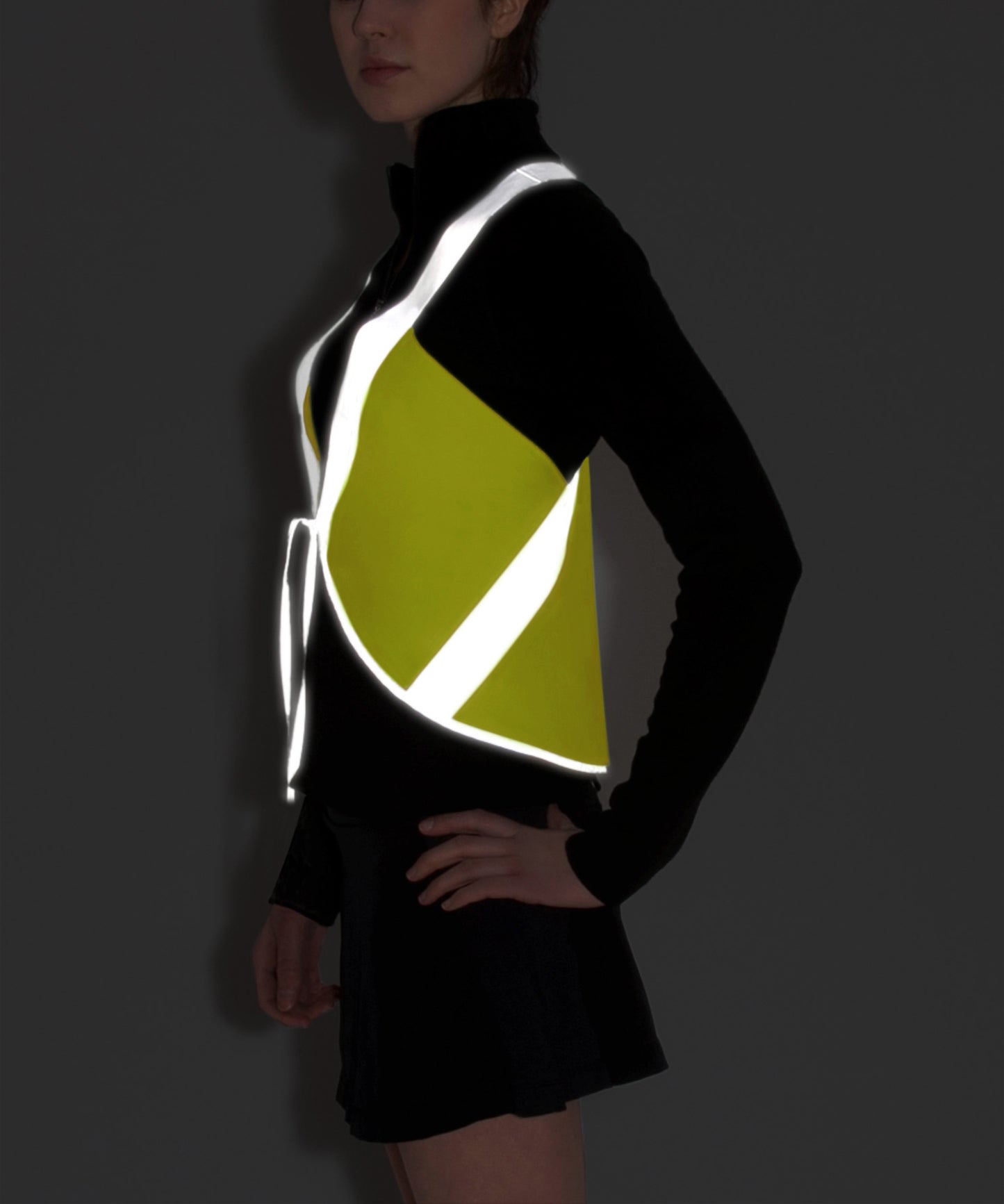 model wears vespert eco citron neon yellow stylish reflective vis safety vest reflecting clothing high visibility gear accessory women fashion bike walk run dog walking walker night sustainable nighttime bright 3M scotchlite made in NYC USA