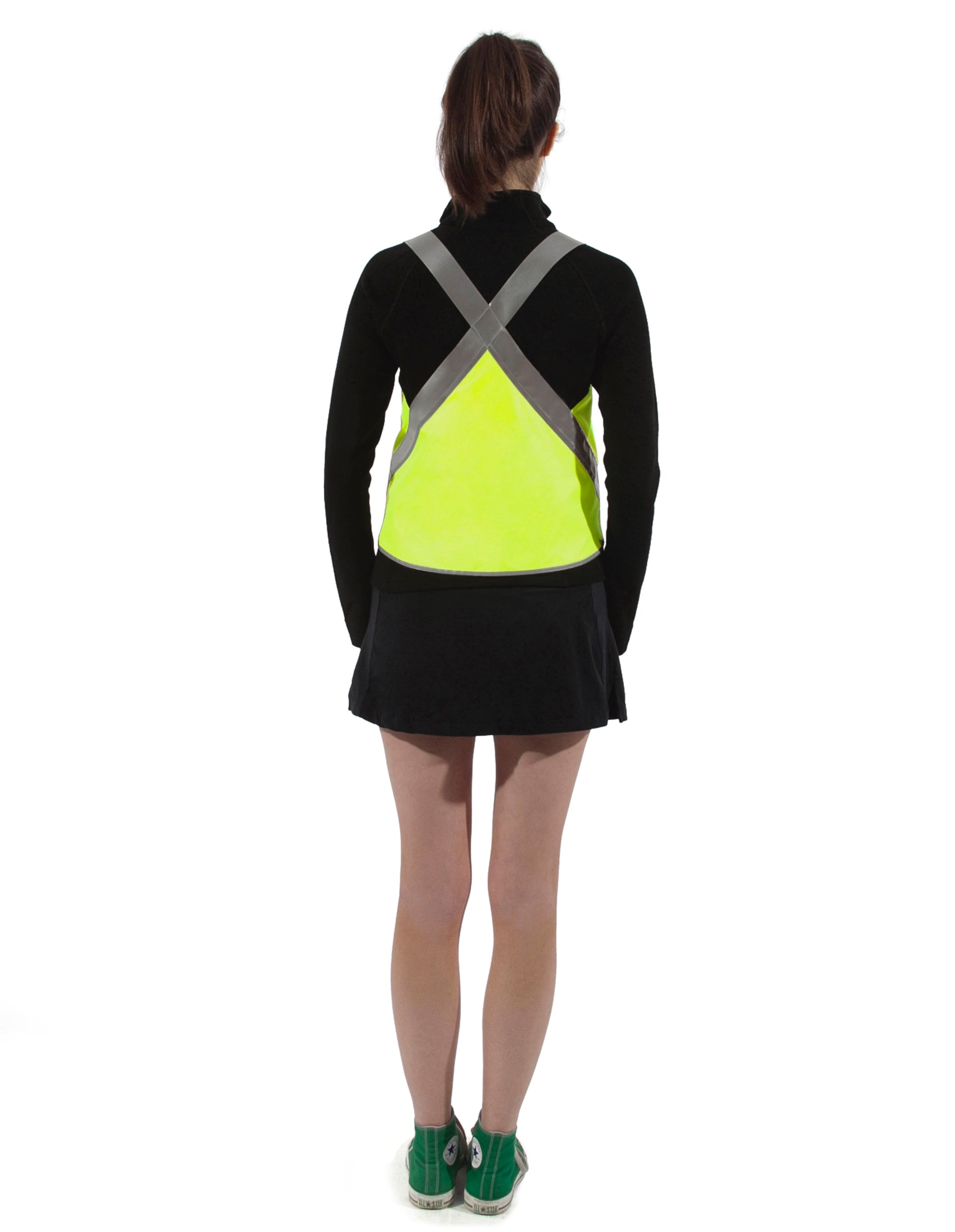 seen from behind model wears vespert eco citron neon yellow stylish reflective vis safety vest reflecting clothing high visibility gear accessory women fashion bike walk run dog walking walker night sustainable nighttime bright 3M scotchlite made in NYC USA