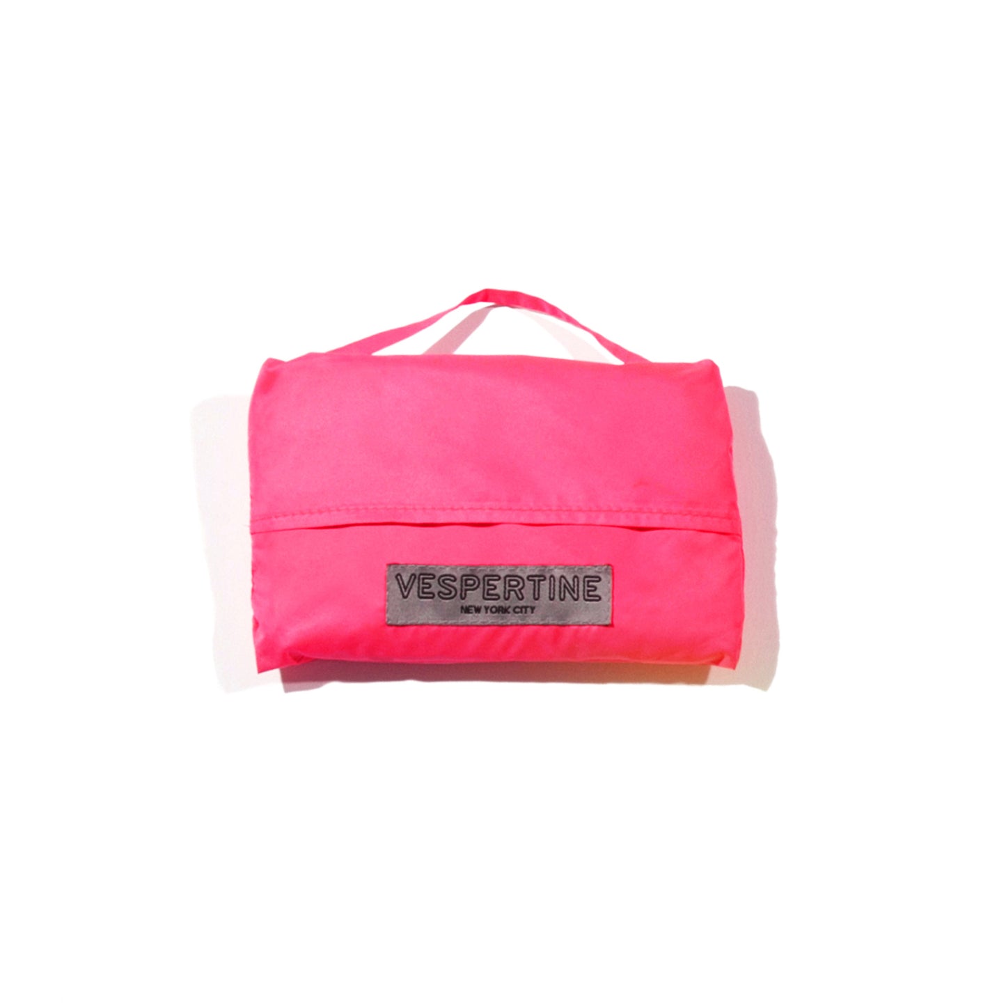 shown packed in cute pouch a vespert eco cotton candy neon pink stylish reflective hi vis safety vest for women reflecting clothing high visibility gear accessory womens fashion bike bike cycling walk run running dog walking walker night sustainable nighttime bright 3M scotchlite made in NYC USA designed to be seen  packable 