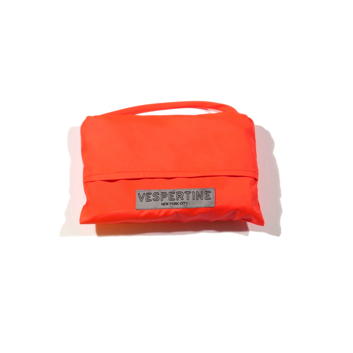 shown packed in cute pouch a vespert eco flame neon orange stylish reflective hi vis safety vest for women reflecting clothing high visibility gear accessory womens fashion bike ebike cycling walk run running dog walking walker night sustainable nighttime bright made of eco-circle recycled polyester and 360 3M scotchlite material in NYC USA designed to be seen day and night packable