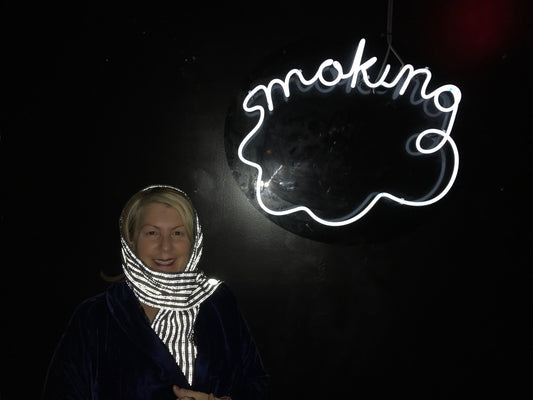 Hollywood Director Rosemary Rodriguez in a Vespertine NYC Reflective MOhair Scarf with the words "Smoking"