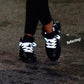 model wears 3M Reflective Shoelaces Brompton X Vespertine NYC flat laces reflecting white 45" 114 cm long made in USA bike walk run be seen hi vis reflective gear on black nike sneakers